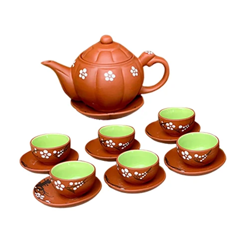 Ấm chia múi dáng bí và sáu chén vẽ hoa trắng, bảy đĩa tròn nâu cam