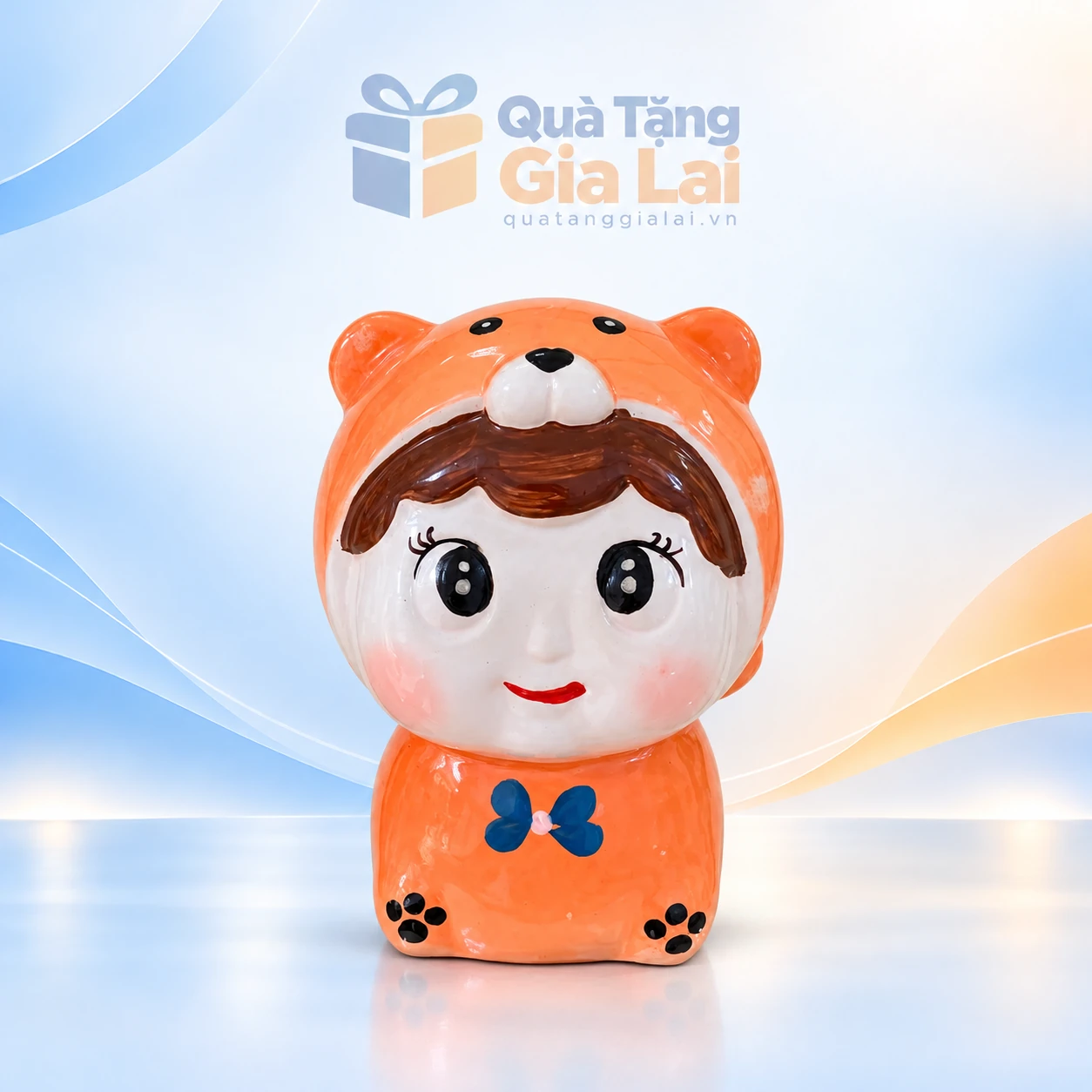 Heo đất búp bê áo gấu cam họa tiết xanh trên nền Gia Lai