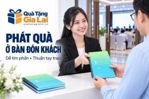 Nhân viên trao sổ bìa xanh chuyển màu cho khách ở bàn đón